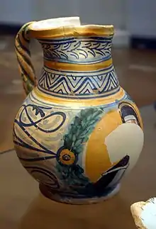 Photo d'un broc ancien, ébréché, peint à la main.