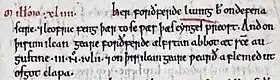 Un morceau d'une page de parchemin portant une indication d'année à l'encre rouge suivie d'un texte en vieil anglais à l'encre noire