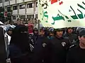 Porte-drapeau en niqab lors d'une manifestation contre les agressions sexuelles massives des femmes pendant l'Aïd au  Caire (2006)