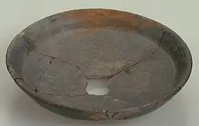 Assiette fragmentaire de couleur marron.