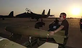 Des membres de l'US Air Force installent des munitions sur un F-15 sur la base Louis Trichardt en  2002.