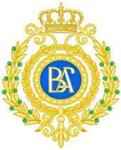 Dessin d'une médaille formée d'un disque central au fond bleu, au centre duquel sont inscrites les deux lettres B et A. Trois cercles dorés constituent le bord de l'objet, le plus excentré étant composé de deux branches de laurier surmontées d'une couronne dorée.