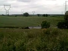 Photographie en couleurs représentant un paysage champêtre.
