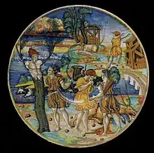 Trois scènes du mythe de Cyparisse sur un émaux à lustre métallique du XVIe siècle par Giorgio Andreoli ; le dieu qui embrasse le jeune qui se transforme tient une branche dans sa main.