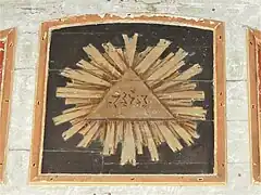 Peinture représentant la Trinité, en haut du retable.