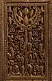 Panneau à décor végétal. La composition axée présente, de part et d'autre d'un arbre stylisé, des boucles renfermant des feuilles de vigne, des pommes de pin et des grappes pendantes.