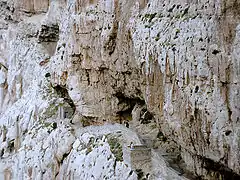 Chemin d'accès aménagé dans la falaise.