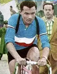 Photographie en couleur d'un cycliste portant un maillot bleu-blanc-rouge.