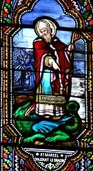 Dernier miracle : Marcel, devenu le 9e évêque de Paris, triomphe d'un dragon venu dévorer une noble matrone qui avait péché et, au moment où il sort de la forêt de Bièvre, il le maîtrise en le frappant trois fois avec son bâton pastoral.Le Bugue, église Saint-Sulpice.