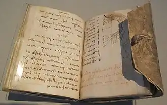 Photo d'un ouvrage manuscrit ouvert.