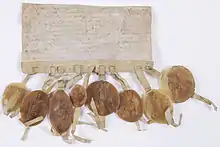 Photographie de la lettre circulaire adressée par les prélats et barons du royaume aux évêques et grands feudataires pour les inviter à assister au Couronnement du jeune Louis IX.