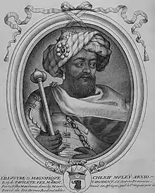 portrait en noir et blanc d'un homme portant barbe et turban tenant un sceptre.