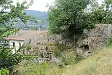 Mur de tuf à l'amont d'un ancien moulin