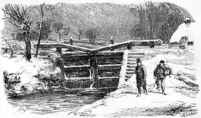 Écluse avec, sur la droite au fond, une petite maison, large chemin enneigé en pente jouxtant la rive où descend un homme plutôt bien habillé, un autre à l'air menaçant, avec un fardeau sous le bras droit hâte le pas pour le rattraper