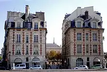 Nos 13 et 15, place du Pont-Neuf, situées de part et d'autre de la rue Henri-Robert menant à la place Dauphine.