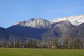 Vue depuis Doussard au nord-est des rocs de la Combe avec à gauche le roc du Four Magnin et en arrière plan à droite le roc des Bœufs.