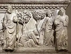 Panneau sculpté en bas et haut-relief représentant deux arbres et quatre hommes dont un agenouillé