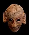 Masque grimaçant, H 0,16 m, terre cuite (fin du VIe siècle av. J.-C.).