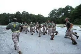 USMC Gunnery Sgt. leads his Marines on a run to the obstacle course 2011.