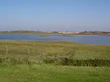 Photo d'une lagune entourée de dunes et de prés salés